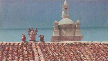 Religious figure above tiled roofs in Ayacucho