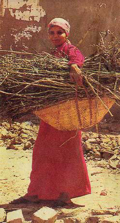 Woman carrying a bundle in an Egyptian village