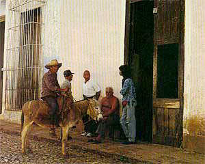 People gathered with a horse outside a doorway