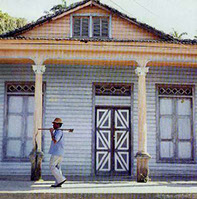 Person walking past a decorated Cuban facade